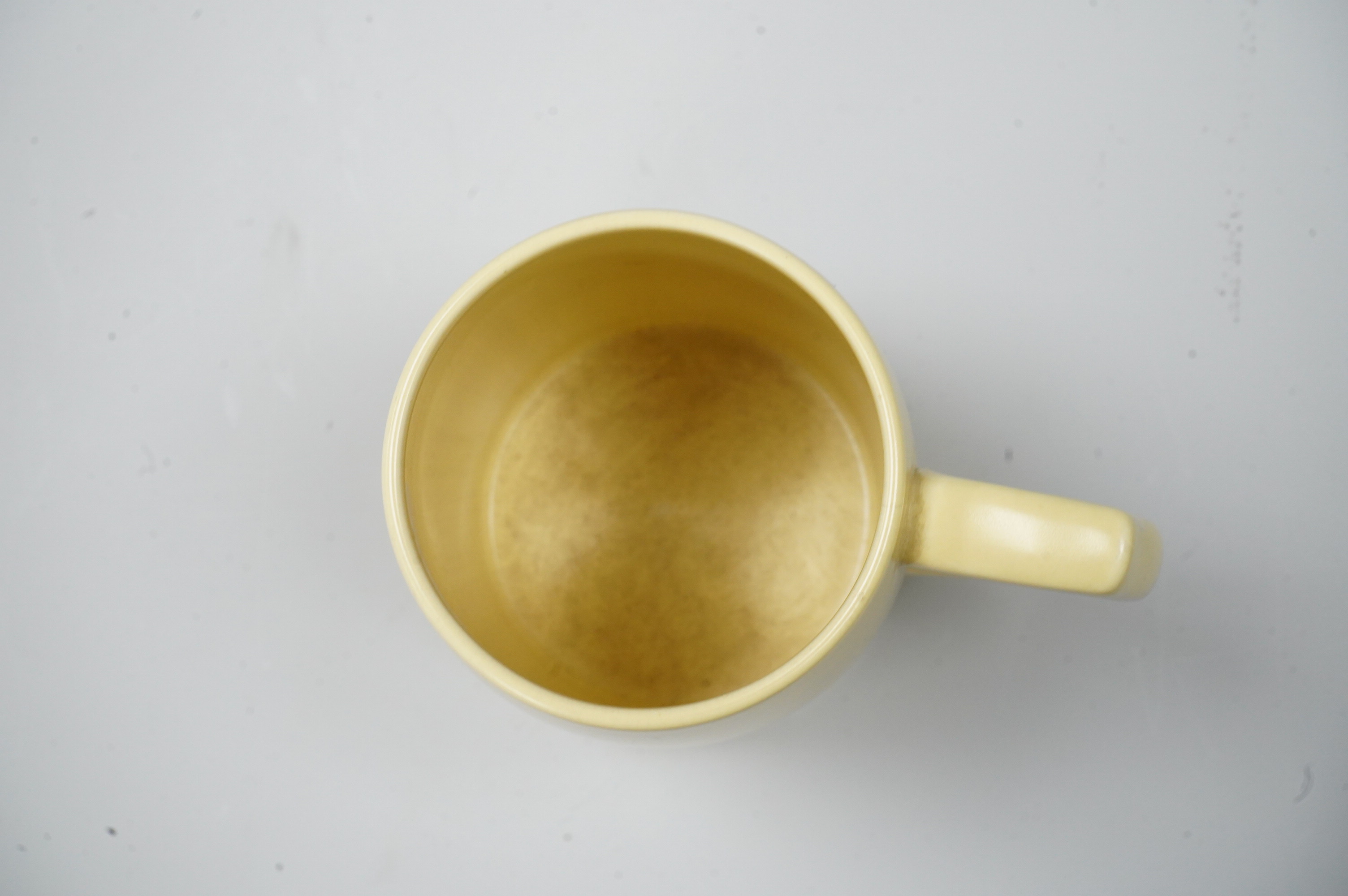 A Keith Murray Wedgwood mug in matt straw, 12cm